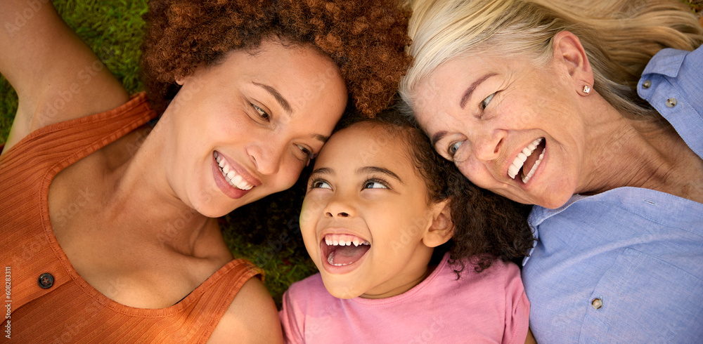 Overhead Portrait Shot Of Multi-Generation Female Family Lying On Grass