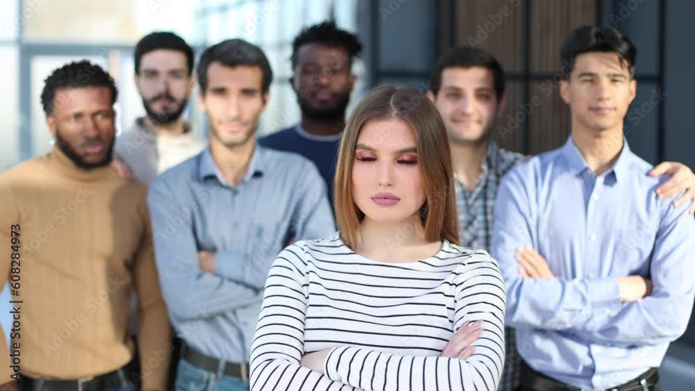 Successful millennial business woman stands at the forefront of a multiethnic team Successful millennial business woman stands at the forefront of a multiethnic team