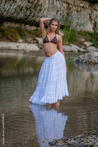 A Lovely Blonde Bikini Model Enjoys The Summer Weather On A Lake