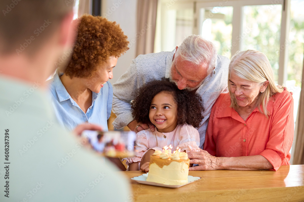 Dad Takes Photo As Multi-Generation Family Celebrate Granddaughter's Birthday At Home With Cake Dad Takes Photo As Multi-Generation Family Celebrate Granddaughter's Birthday At Home With Cake