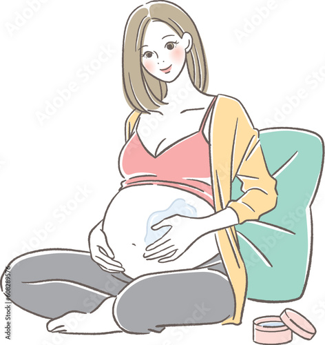 お腹にクリームを塗る妊婦