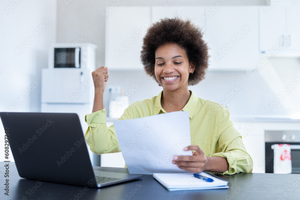 Happy smiling remote working young black female receive postal letter from company office about project report approval. Glad millennial afro american employee reading good news from paper document. Happy smiling remote working young black female receive postal letter from company office about project report approval. Glad millennial afro american employee reading good news from paper document.