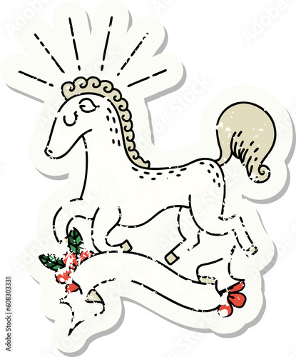 worn old sticker of a tattoo style prancing stallion