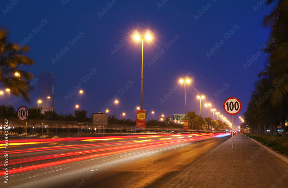 Urban street in the city at night with vivid color car light trails