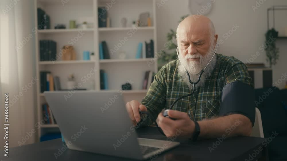 Elderly man with beard measuring blood pressure, video call with therapist Elderly man with beard measuring blood pressure, video call with therapist