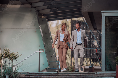 Modern business couple after a long day's work, walking together towards the comfort of their home, embodying the perfect blend of professional success and personal contentment.