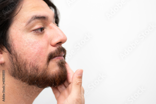 Side view of face of man arabian with beard washing his face with water in white background and copy space