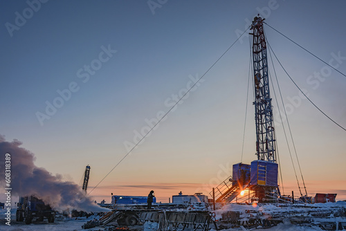 Well repair at a gas field in the Arctic. Winter polar evening. Frost. Snow. Mobile rig for well repair with a derrick and other equipment