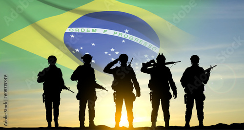 Silhouette of a soldiers against the sunset with Brazil flag. Armed Forces of Brazil concept. EPS10 vector