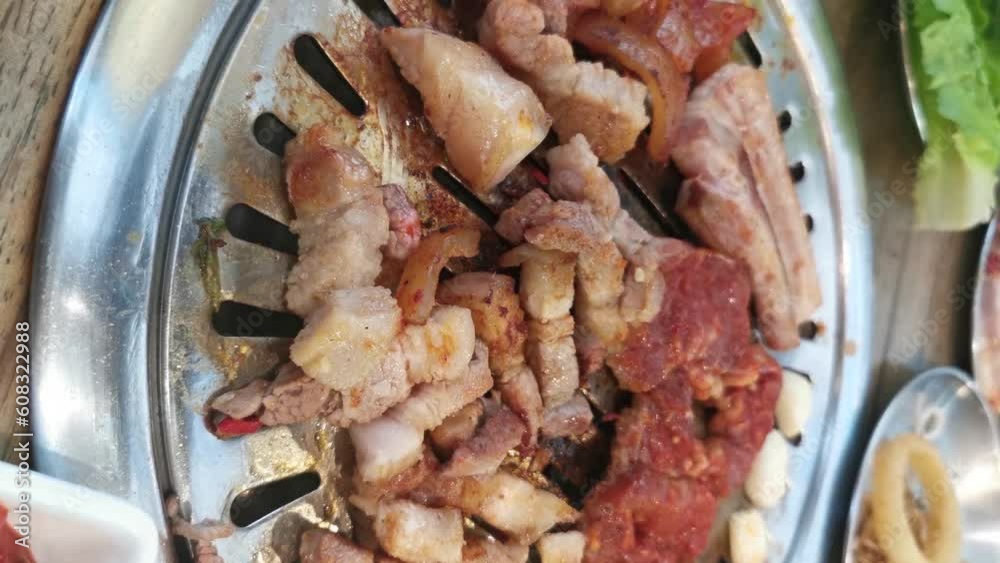 Korea bbq, Pork grilled. concept of Korean or Japanese local food. A delicious or yummy pork grilled. A hand picking up a piece of pork grilled Hot and fresh lunch. Vertical BBQ video. Home party meal Korea bbq, Pork grilled. concept of Korean or Japanese local food. A delicious or yummy pork grilled. A hand picking up a piece of pork grilled Hot and fresh lunch. Vertical BBQ video. Home party meal