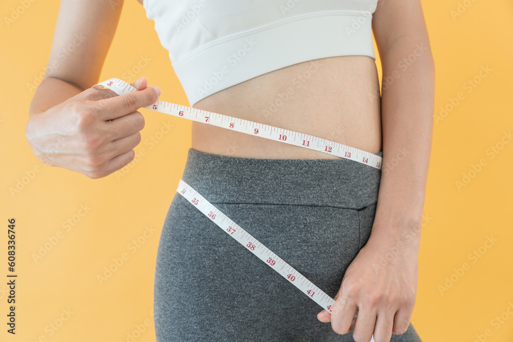 Diet and dieting. Beauty slim female body use tape measure. Woman