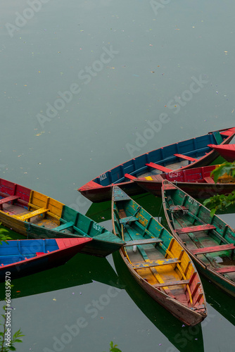 Boats floating on calm waters. Unconventional arrangement forms an intriguing, uncomposed composition. (ID: 608359570)