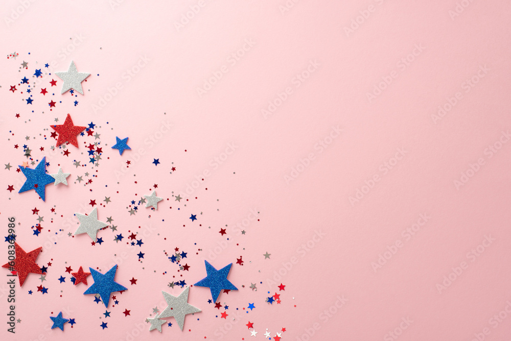 Celebrate in style with this top-down view of Independence Day decorations: sparkling stars and confetti against a pastel pink background with an empty space for text or advertising