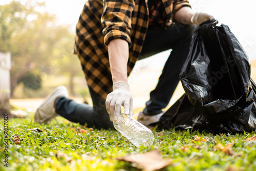 Closeup image of a hand picking up trash on World Environment Day,  showcasing our dedication to cleaning and protecting our planet.