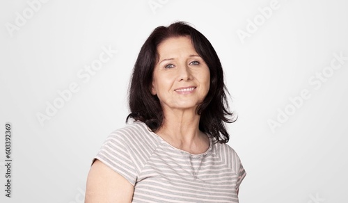 Elderly happy beautiful woman posing on background