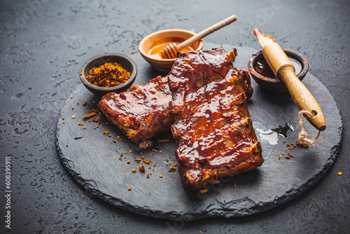 Barbecue pork spare ribs with hot honey chili marinade on black background