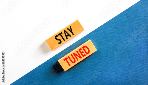 Stay tuned symbol. Concept words Stay tuned on wooden blocks on a beautiful white and blue background. Business, support, motivation, psychological and stay tuned concept. Copy space.