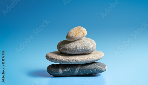 Balanced zen stones on abstract blue background