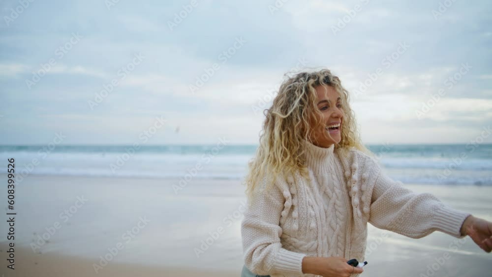 Romantic girl holding kite string at beautiful ocean view. Cheerful mother play Romantic girl holding kite string at beautiful ocean view. Cheerful mother play