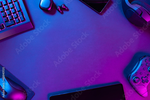 Various modern wireless gadgets on illuminated desk