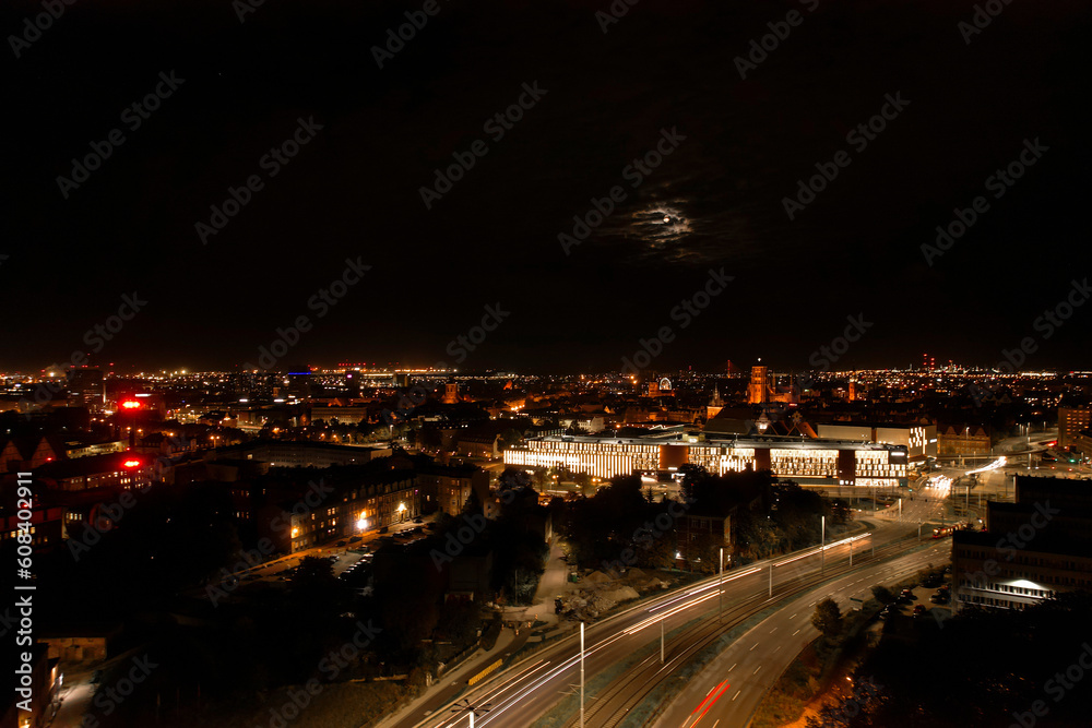 Top down view to road. Romantic night aerial photo of cars traveling. The light on the road at night in city. Background scenic road drone view. Tram railways background