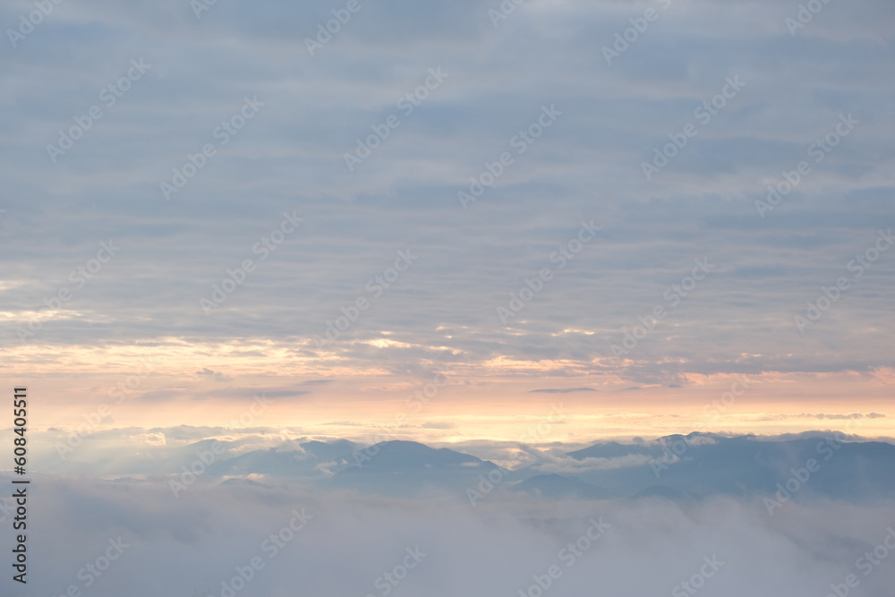 Fototapeta premium A mountain obscured by white mist at dawn