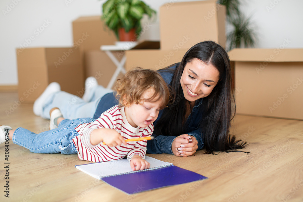 Cute Little Boy And His Mother Relaxing On Floor After Moving Home Cute Little Boy And His Mother Relaxing On Floor After Moving Home
