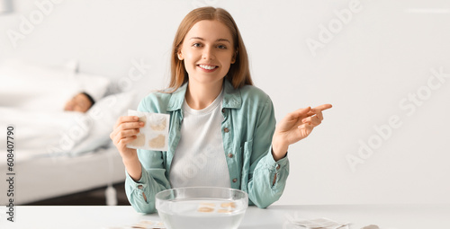 Young woman with mustard plaster at home photo