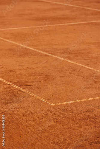 tennis court made of red clay soil with markings for game or competition. sports and recreation, professional performance champions in lawn tennis with rackets and balls. training of athletes outdoor