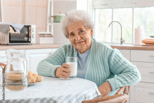 Senior woman with glass of milk in kitchen