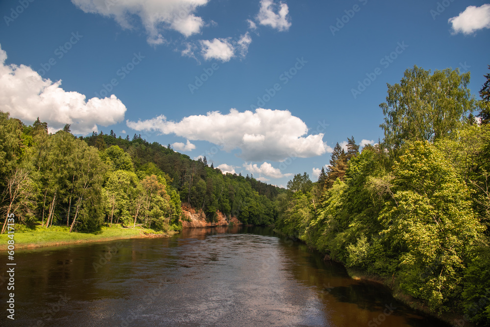 Landscape view of red sandstone caves on Gauja river in Sigulda, Latvia on a sunny summer day