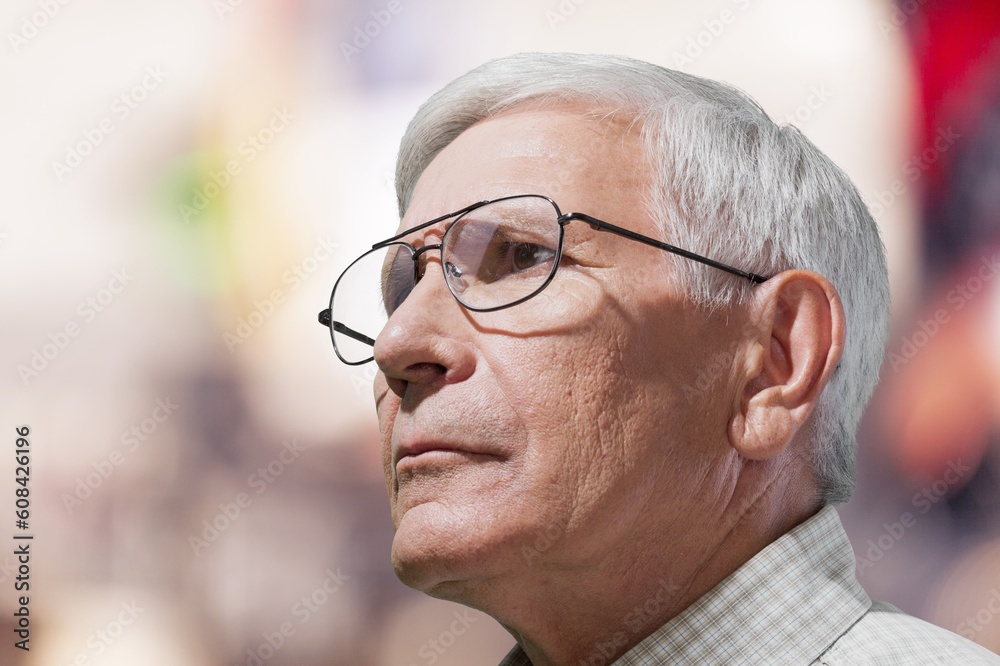 Pensive old man looking in distance of window Pensive old man looking in distance of window