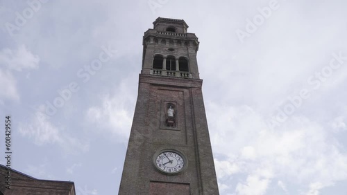 Ancient clock tower with clouds in the background