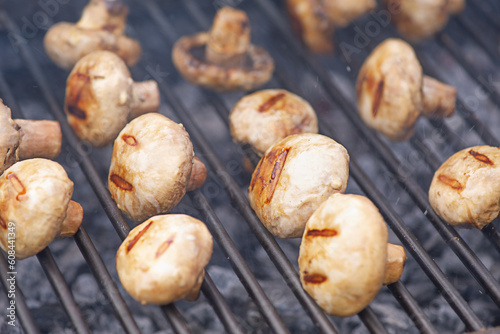 Mushrooms are cooked on the grill. Delicious mushrooms on the fire.
