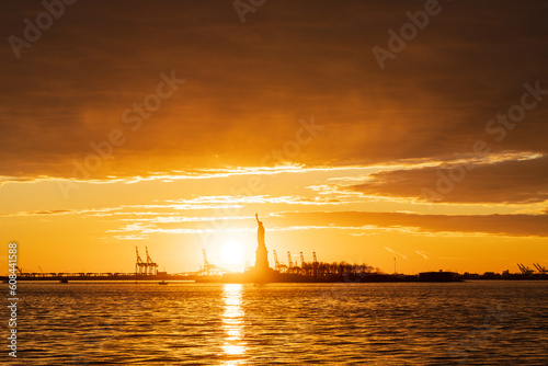 Sunset in New York passing through the statue of liberty of Liberty 