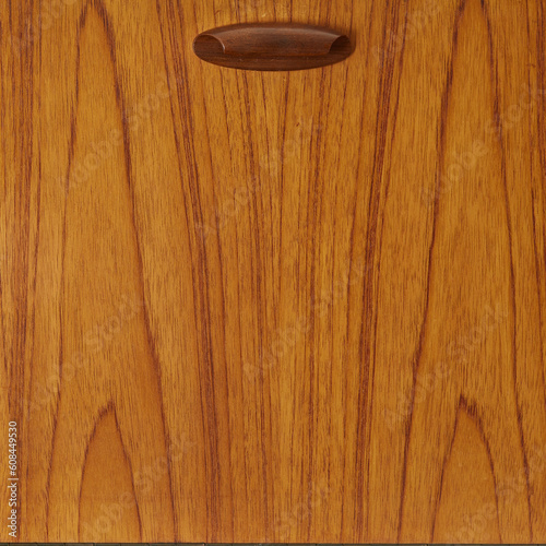 Stylish vintage 1960s room divider. Classic Mid-Century Modern teak sideboard. Refined sculptural furniture. Detail photograph of the pull-down door. 