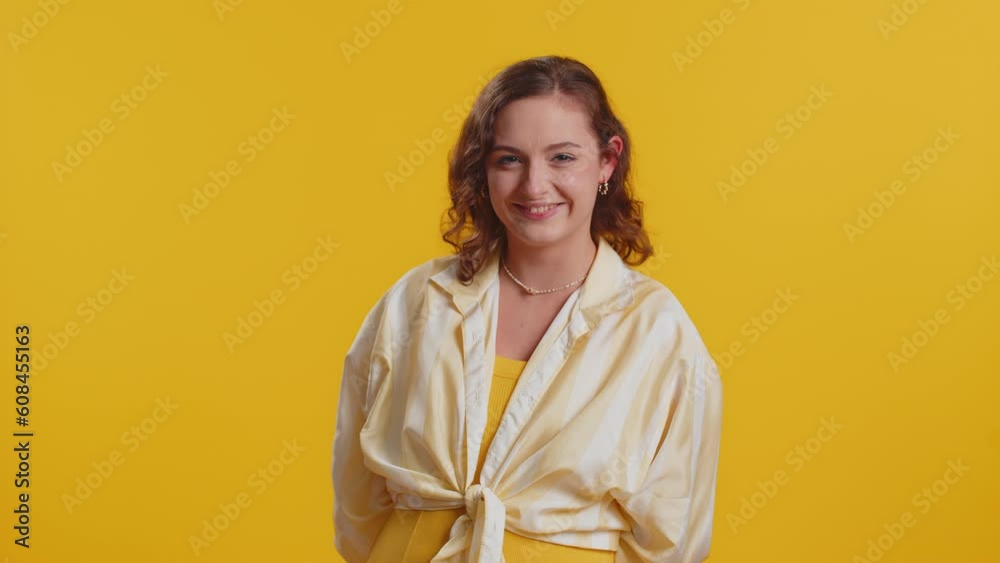 Cheerful funny young woman showing tongue making faces at camera, fooling around, joking, aping with silly face, teasing, bullying, abuse. Girl isolated alone on yellow studio background. Lifestyles Cheerful funny young woman showing tongue making faces at camera, fooling around, joking, aping with silly face, teasing, bullying, abuse. Girl isolated alone on yellow studio background. Lifestyles