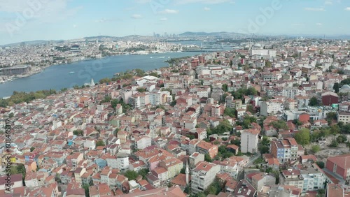 Drone flyover ayvansaray neighborhood capturing beautiful european side cityscape on both side of golden horn estuary at daytime