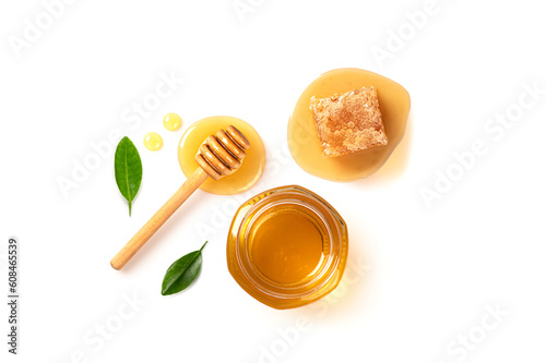 Honey in jar with honey comb isolated on white background. Top view
