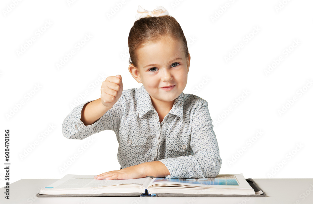 Confident elementary-aged schoolgirl sitting at the desk Confident elementary-aged schoolgirl sitting at the desk