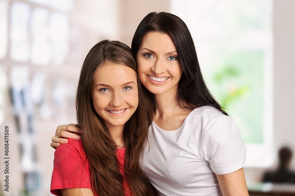 Young loving happy mother hugging teen daughter Young loving happy mother hugging teen daughter