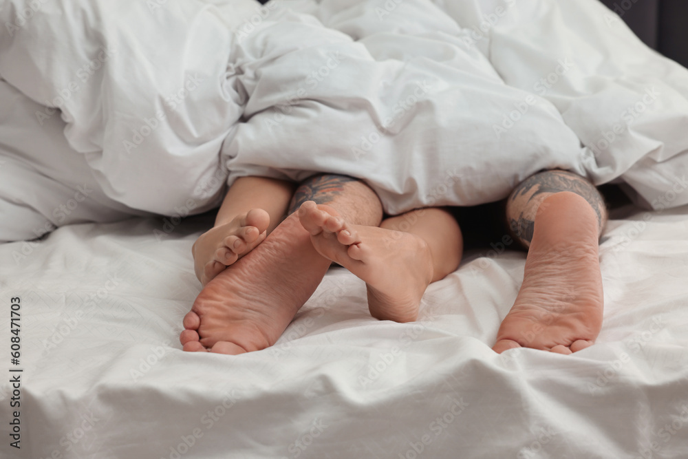 Passionate couple having sex on bed, closeup of legs Passionate couple having sex on bed, closeup of legs