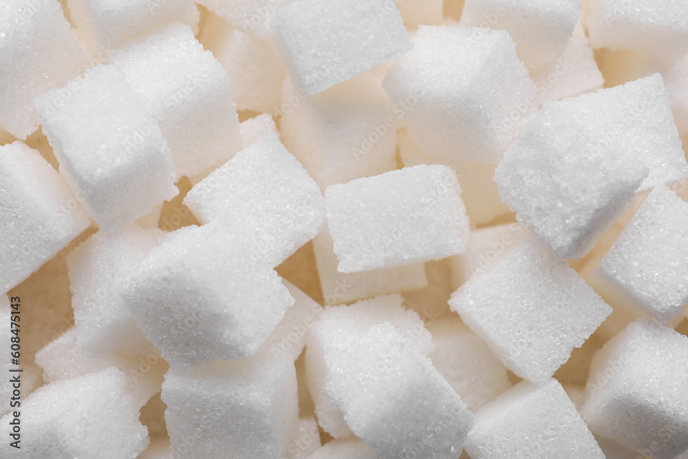White refined sugar cubes as background, closeup