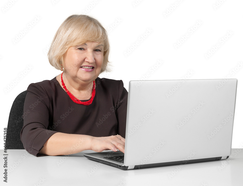 Old Woman Sitting behind Table and Typing on a Laptop - Isolated Old Woman Sitting behind Table and Typing on a Laptop - Isolated