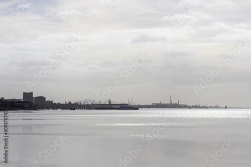 sea landscape with view of ports and city in morning sunlight