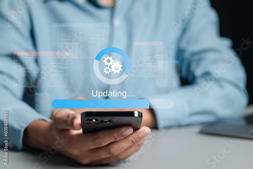 Businessman working and installing update process. Software updates or operating system upgrades to keep your device up to date with enhanced functionality in new versions and improved security.