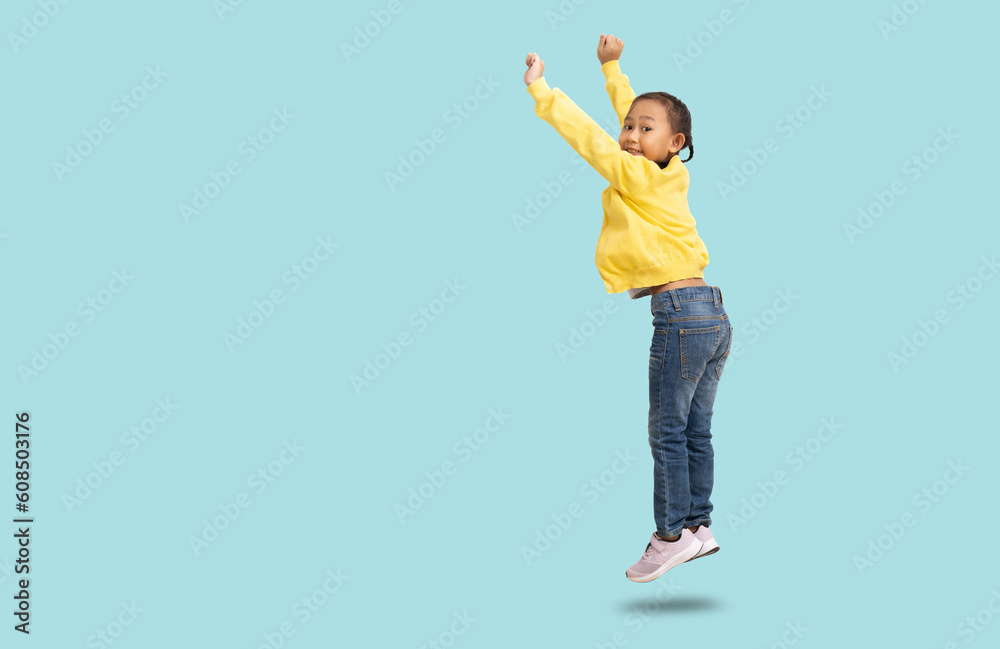 School girl, Happy smiling Asian student school kid jumping for joy, Full body portrait isolated on pastel plain light blue background School girl, Happy smiling Asian student school kid jumping for joy, Full body portrait isolated on pastel plain light blue background