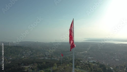 Aerial view of the glorious Turkish flag waving from the hill, which has the most beautiful view of Istanbul, which sees the bridge connecting Asia and Europe.