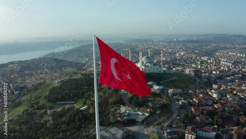 Aerial view of the glorious Turkish flag waving from the hill, which has the most beautiful view of Istanbul, which sees the bridge connecting Asia and Europe.
