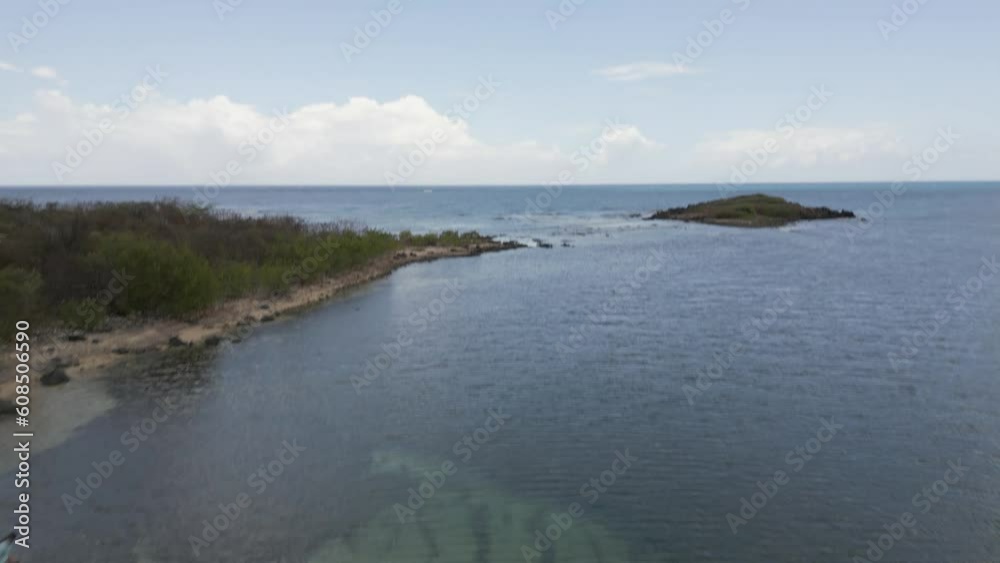 Drone shot panning up to reveal small island at a beautiful tropical beach in Puerto Rico Drone shot panning up to reveal small island at a beautiful tropical beach in Puerto Rico